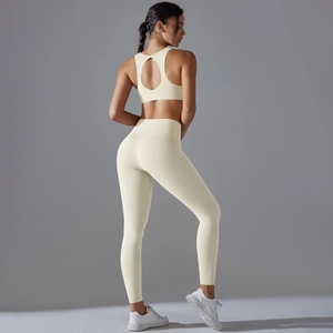 Detail of high-stretch cream yoga set featuring an open-back sports bra and leggings