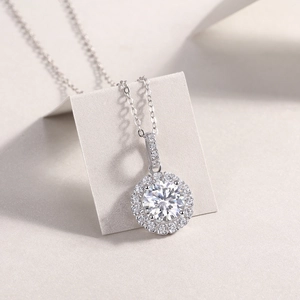 Macro detail of S925 silver halo pendant necklace with a 2-carat round cut moissanite stone