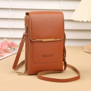 Detail of caramel faux leather phone crossbody bag with gold hardware and logo print