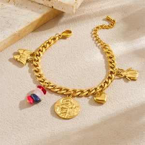 Detail of gold-plated chain bracelet with vintage rose charms and natural stone accents