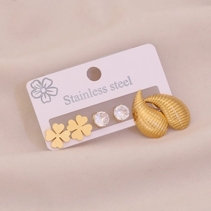 Set of three stainless steel earrings featuring clover studs, cubic zirconia, and gold rings