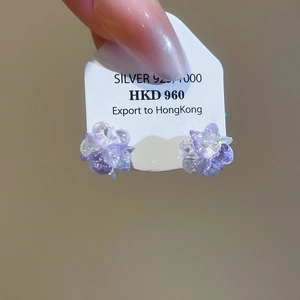 Macro shot of purple crystal floral stud earrings featuring S925 sterling silver posts