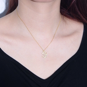 Elegant gold S925 sterling silver Om symbol necklace on a female model neck