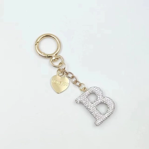 Detail of silver letter B keychain with golden heart tag engraved I LOVE YOU
