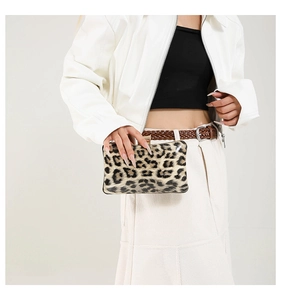 Detail shot of leopard print evening clutch bag with metal clasp and chain strap
