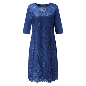 Detailed close-up of dark blue lace embroidery and hollowed-out texture on dress sleeve