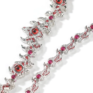 Detailed view of silver spine chain necklace featuring red eye stones in punk gothic style