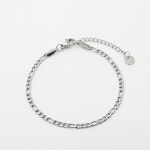 Flat lay of silver Figaro chain bracelet with adjustable extender and lobster clasp