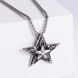 Detail of vintage punk star pendant featuring engraved texture on polished silver chain