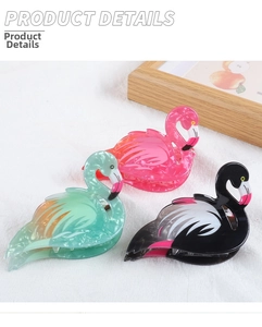 Detail showing acrylic flamingo hair claws in pink, teal, and black marble textures