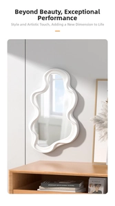 Close-up of cloud shaped mirror with white wavy frame mounted on a gray wall