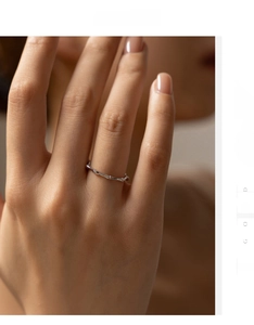 Detail shot of a minimalist S925 sterling silver bamboo joint ring worn on a finger