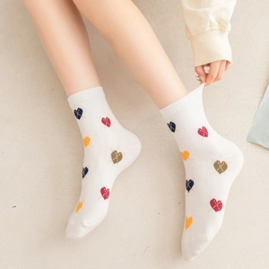 Japanese style white mid-calf socks featuring colorful heart diamond patterns and ribbed cuffs