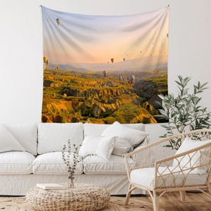 Detail of bohemian tapestry featuring hot air balloons over Cappadocia landscape