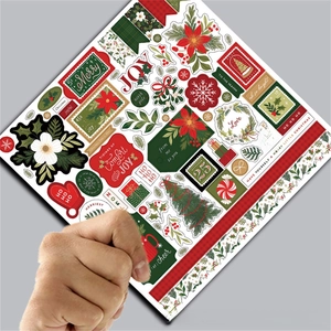 Close-up of vintage Christmas scrapbooking paper with festive tree and holly patterns