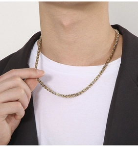Detail einer 4 mm zweifarbigen gold-silbernen Byzantiner-Kette an einem männlichen Model