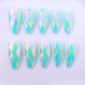 Macro detail of almond-shaped Aurora nails with 3D diamond geometric faceted surfaces