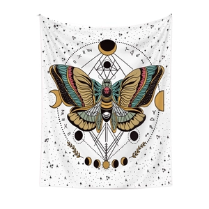 Close-up of bohemian tapestry with moth design, zodiac signs, and lunar phases