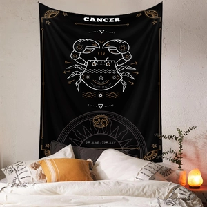 Detailed view of black Cancer zodiac tapestry with gold celestial crab art in a bedroom