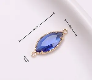 Marquise-cut blue crystal connector in gold finish with 21mm length and 9mm width dimensions