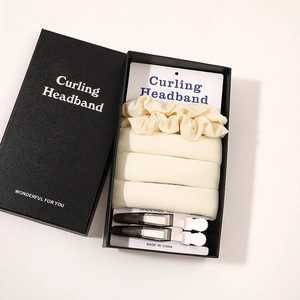 Detail view of a premium heatless curling set neatly arranged in a black gift box