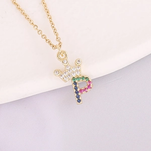 Macro shot of 18K gold crown necklace with colorful zircon letter P pendant detail