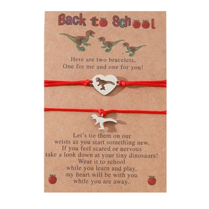 Detail of red rope dinosaur bracelets on Back to School card for mother and daughter