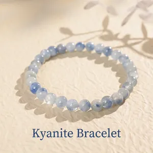 Elegant blue kyanite bead bracelet with cat eye effect on a textured beige background