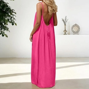 Detail of fuchsia backless maxi dress showing thin straps and lace-up back design