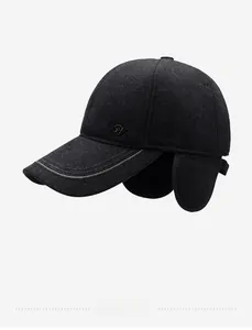 Detail of winter baseball cap with ear flaps and metallic wing icon in dark gray