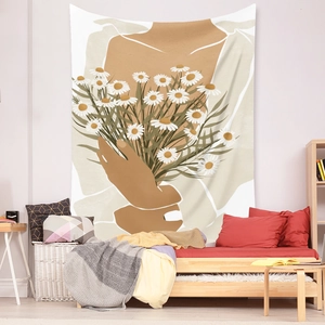 Detail of bohemian tapestry featuring an abstract person holding daisies on a bedroom wall