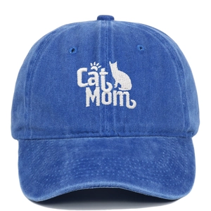 Close-up of Cat Mom embroidery on a washed blue vintage-style baseball cap