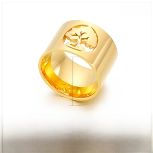 Macro shot of 15mm wide gold hollow tree of life pattern on polished stainless steel ring