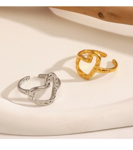 Detail view of heart-shaped adjustable rings with hammered texture in gold and silver