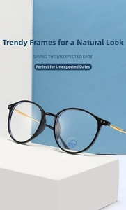 Detailed shot of black frame glasses with gold metal temples and blue light lenses