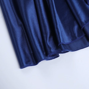 Detail shot of smooth navy blue satin fabric showing silky texture and elegant draping