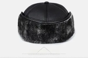 Detail view of the back of a winter PU leather baseball cap with grey faux fur ear flaps