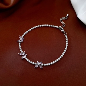 Detail of silver tennis bracelet with purple zircon butterflies and lobster clasp