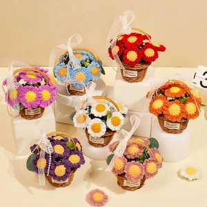 Detail of colorful handmade crochet flower baskets with textured yarn and pearl straps