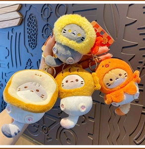 Detail of four plush cat keychains featuring lion, bread, and flower costume designs