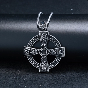 Detailed macro view of vintage silver Celtic knot cross pendant in stainless steel