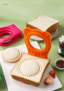 Macro shot of orange sandwich embosser sealing bread edges with round serrated texture
