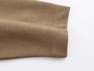 Detailed close-up showing the soft knitted texture and stitching of the brown sleeve cuff