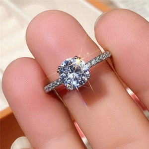 Classic six-prong solitaire ring with a round zircon and pave band in silver finish