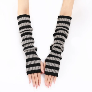 Detail view of knitted arm warmers featuring classic black and grey striped pattern