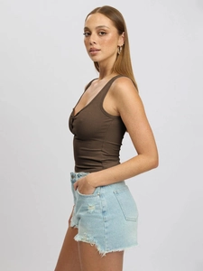 Detail shot of brown ribbed slim fit tank top paired with light blue denim shorts