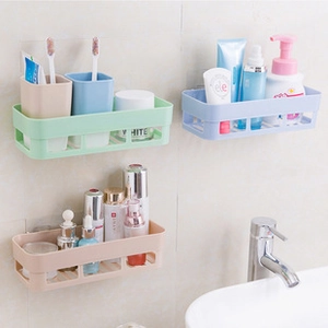 Wall-mounted plastic bathroom shelf in green, blue, and beige with drainage design