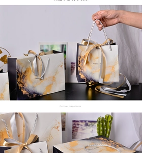 Detailed macro view of marble pattern gift bags with elegant ribbon bow handles