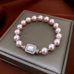 Elegant pearl bracelet featuring a rectangular mother-of-pearl charm with pave crystals