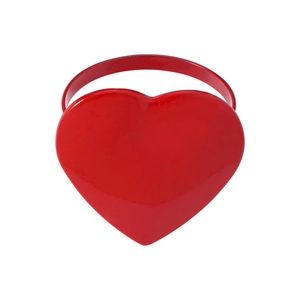 Close-up of a polished red heart-shaped metal napkin ring for wedding and table decor